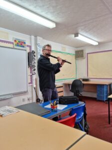 A man demonstrates playing the flute